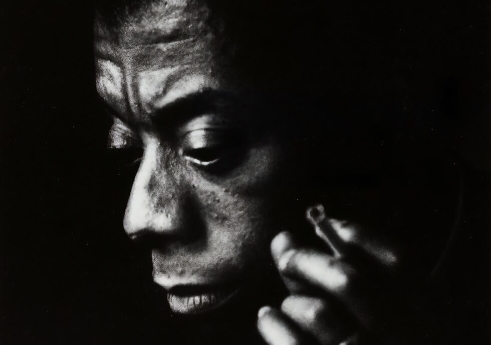 a black and white photo of a man talking on a cell phone